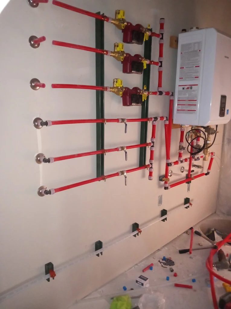 Fire suppression system piping and valve installation on wall with control panel