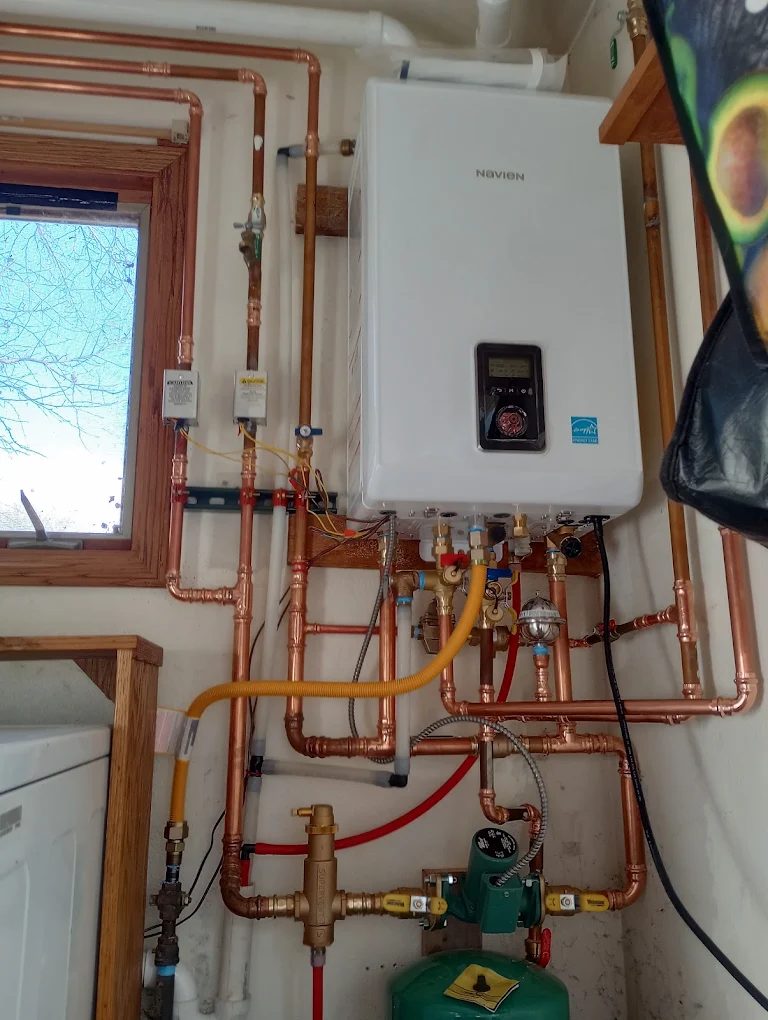 Navien tankless water heater with copper piping and heating system installation